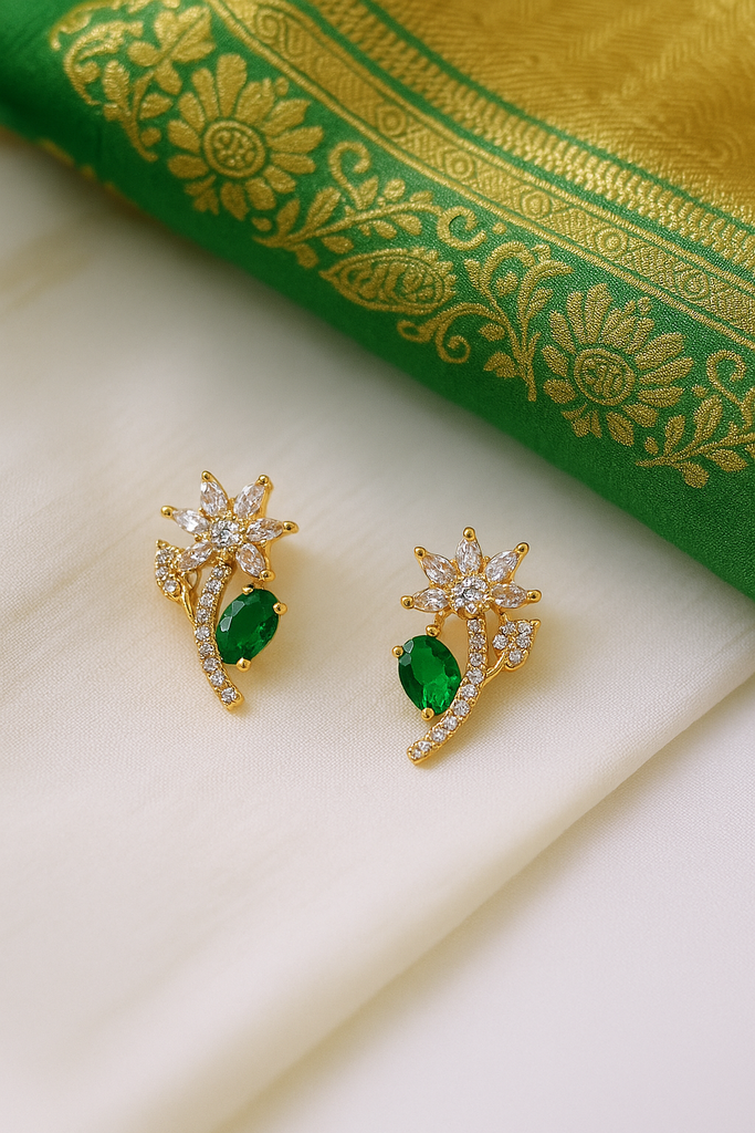 Emerald Petal Studs: Highlights the green stone and the floral shape.